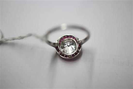 An early 20th century platinum and single stone diamond ring with ruby set yellow gold border, size K/L.